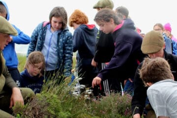 A group of children looking at plants