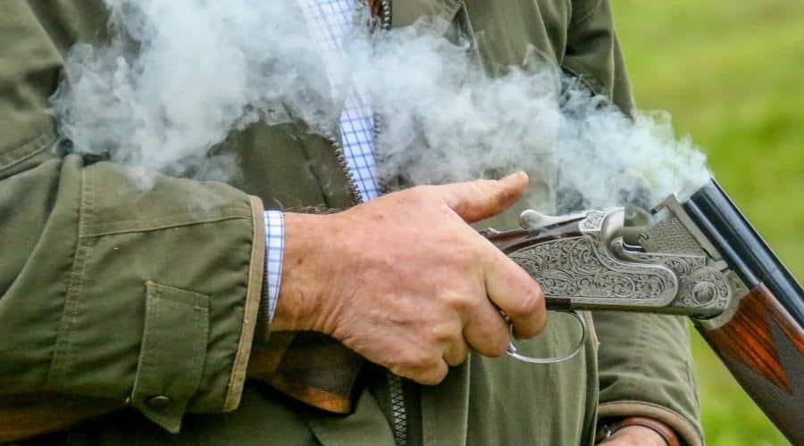 A shotgun ejecting a cartridge with smoke