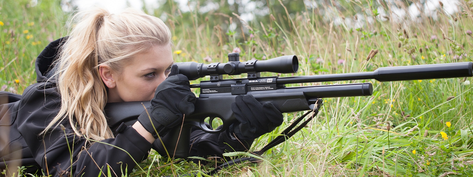 A shooter aiming down the scope of their air rifle