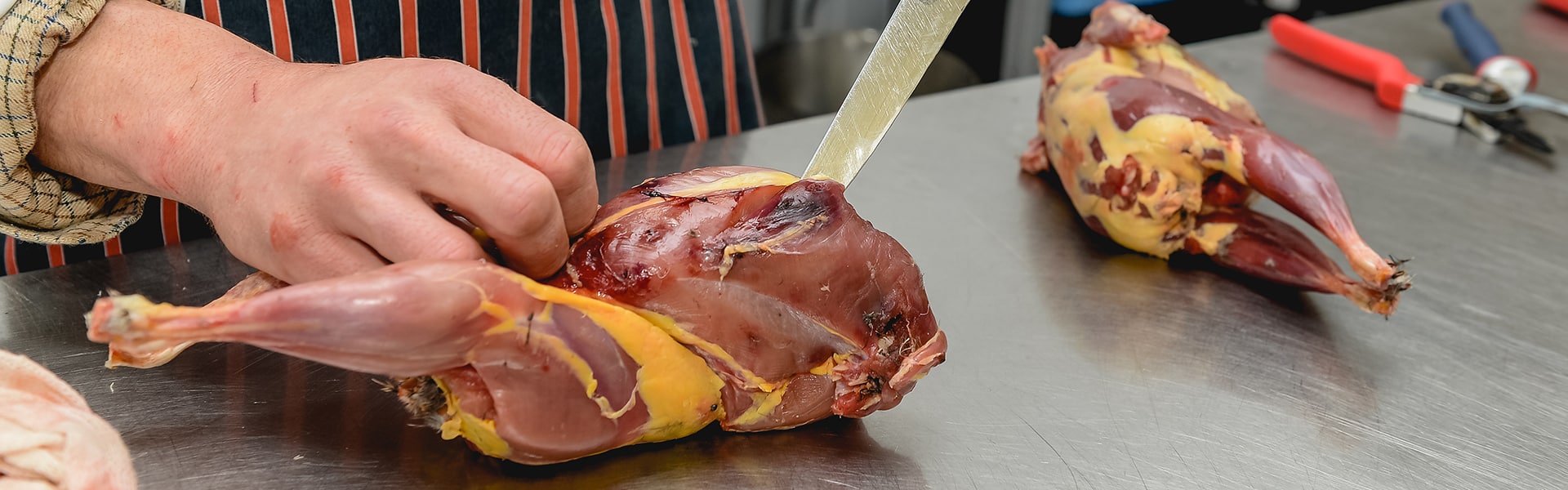 A game meat butcher preparing meat