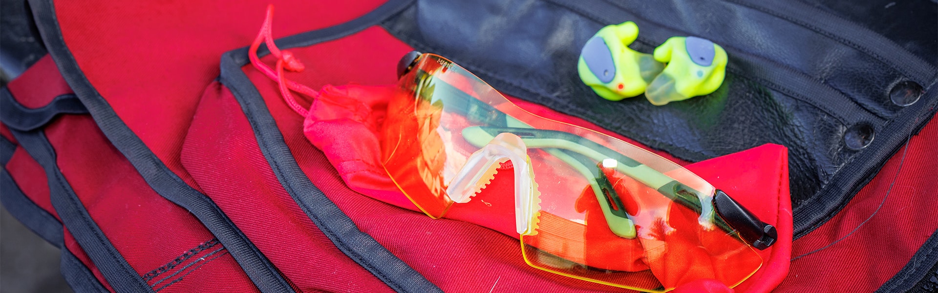 A pair of safety glasses and ear plugs on a safety vest - Image by Matt Kidd