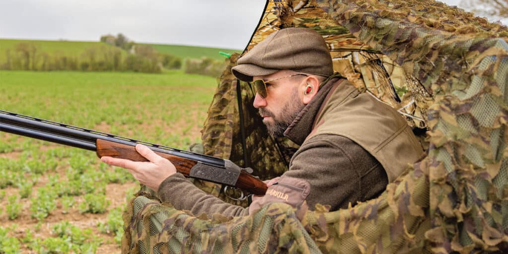 A pigeon shooter in a hide