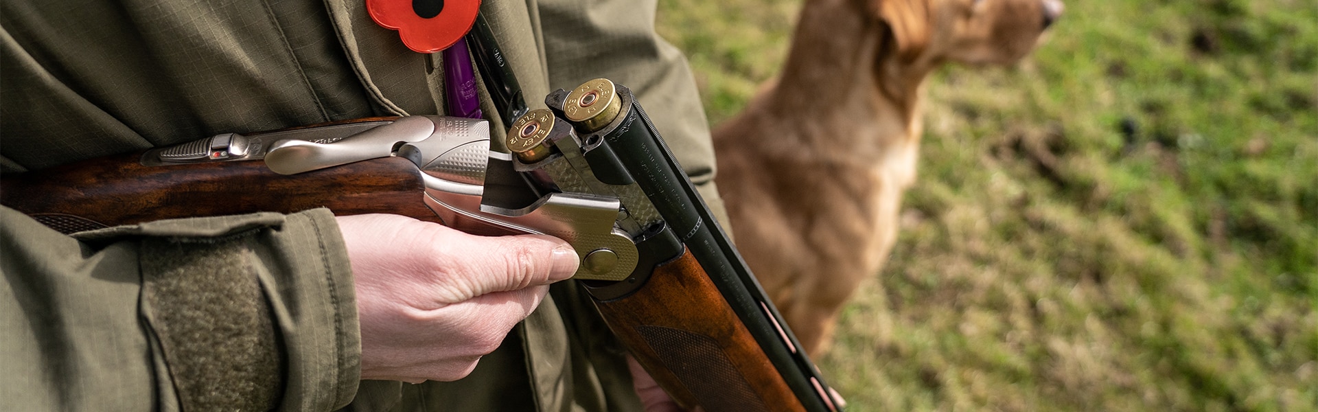 A shooter holding a broken shotgun