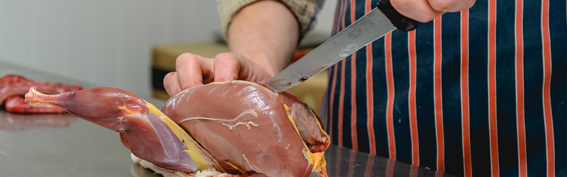 A chef preparing small game meat