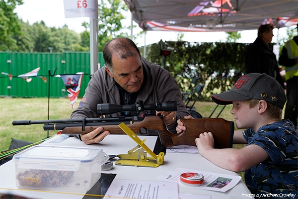 A young shot being coached with their air rifle