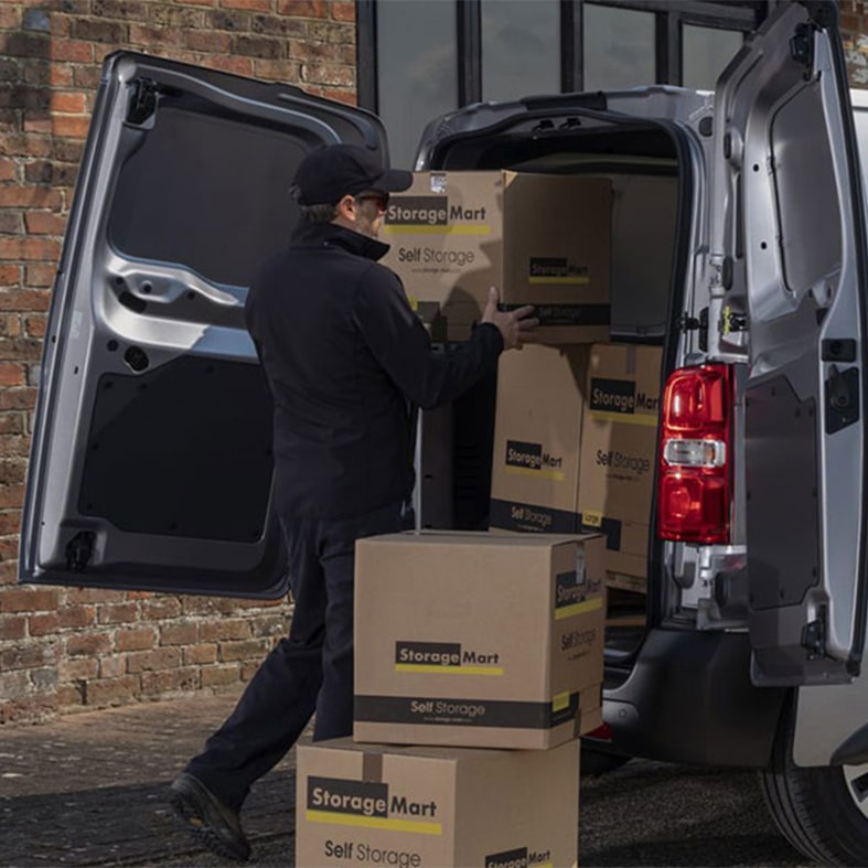 A man loading the back of a van