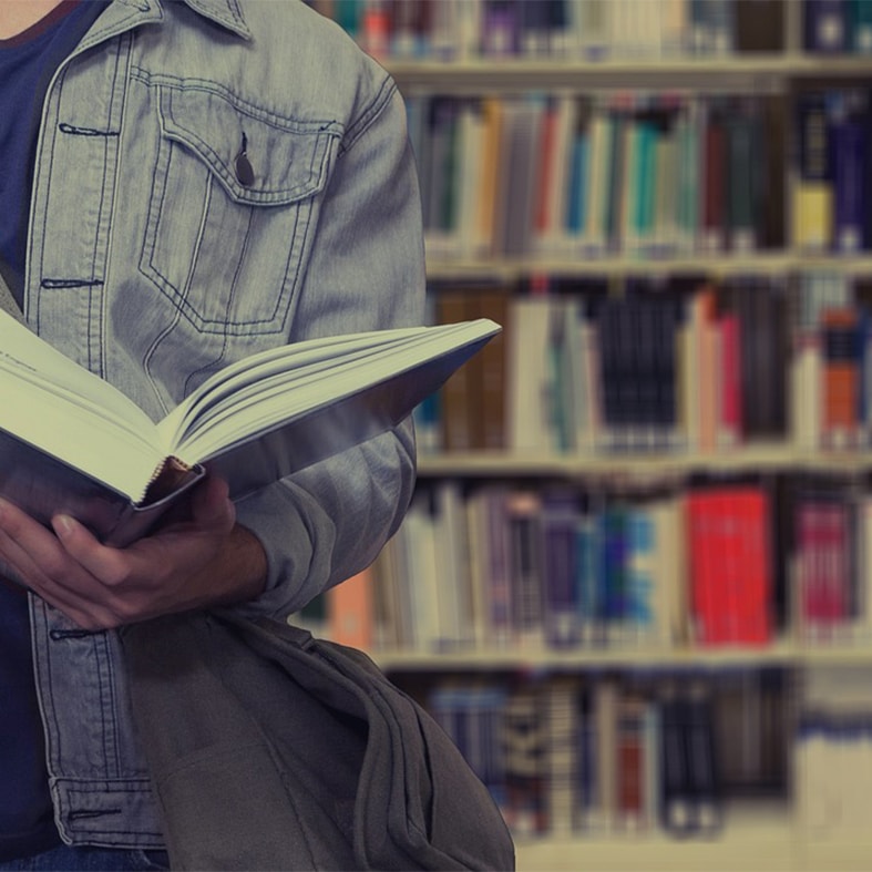 A man reading a book in a library