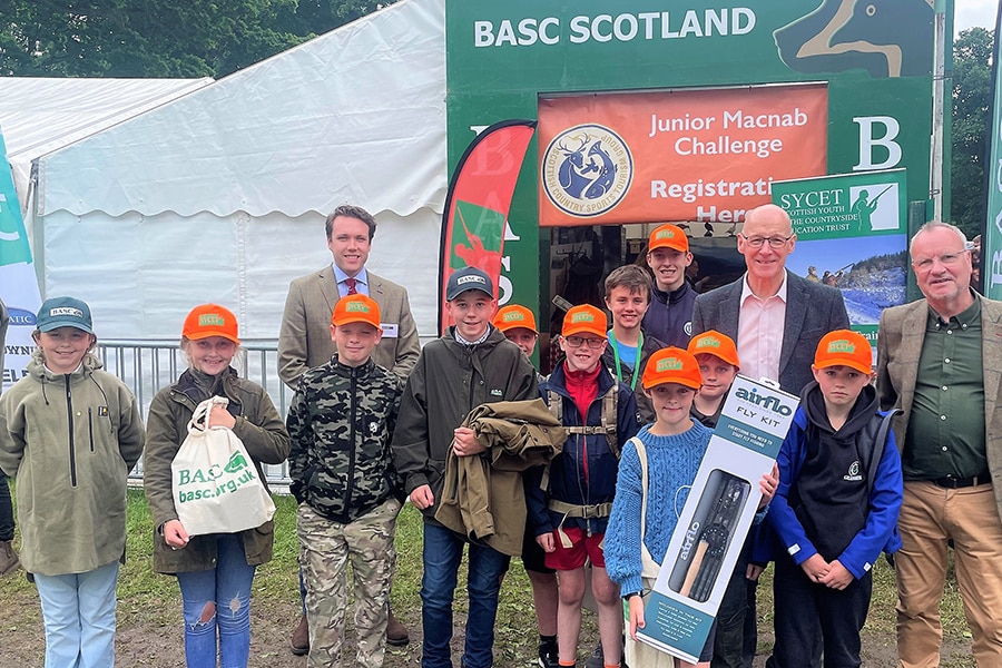 A group of young people standing outside of the BASC Scotland stand