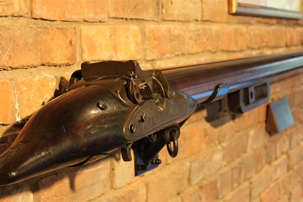 An antique firearm hung on a wall