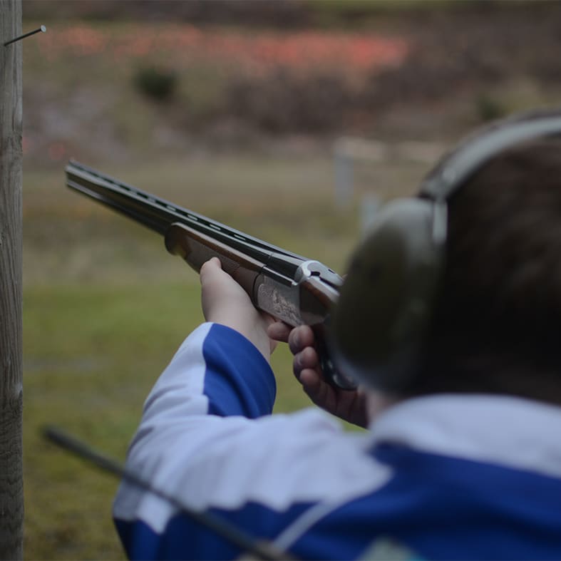 A young shot holding a shotgun