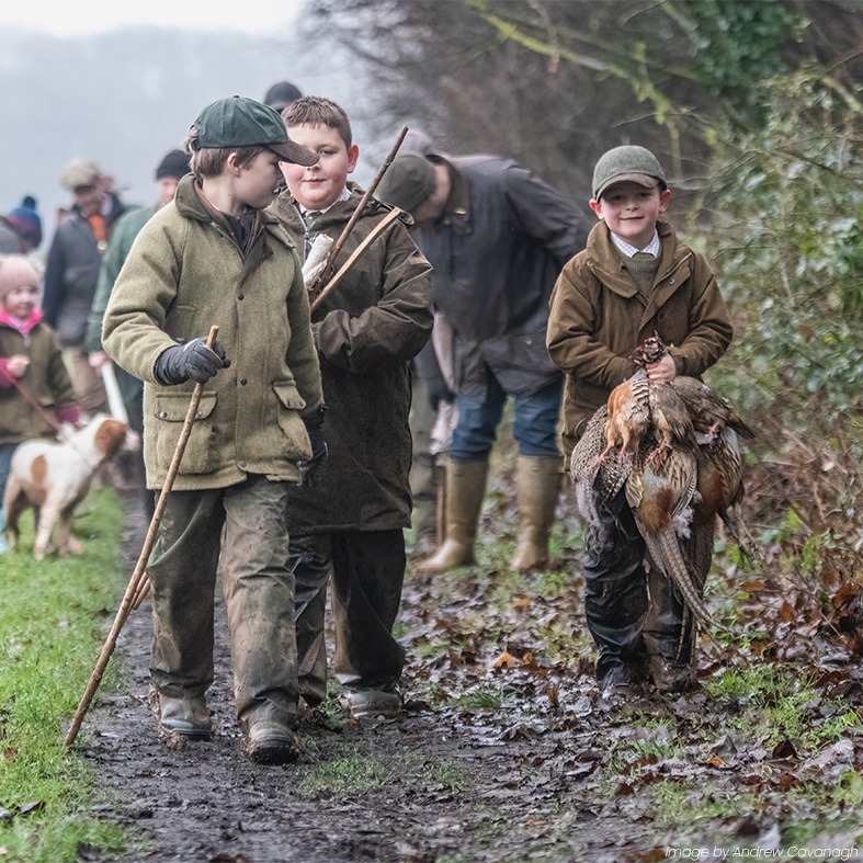 Young shooters walking together along a country land