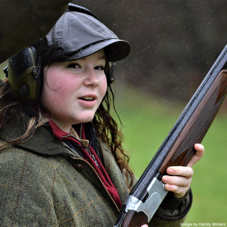 A young shot holding a shotgun