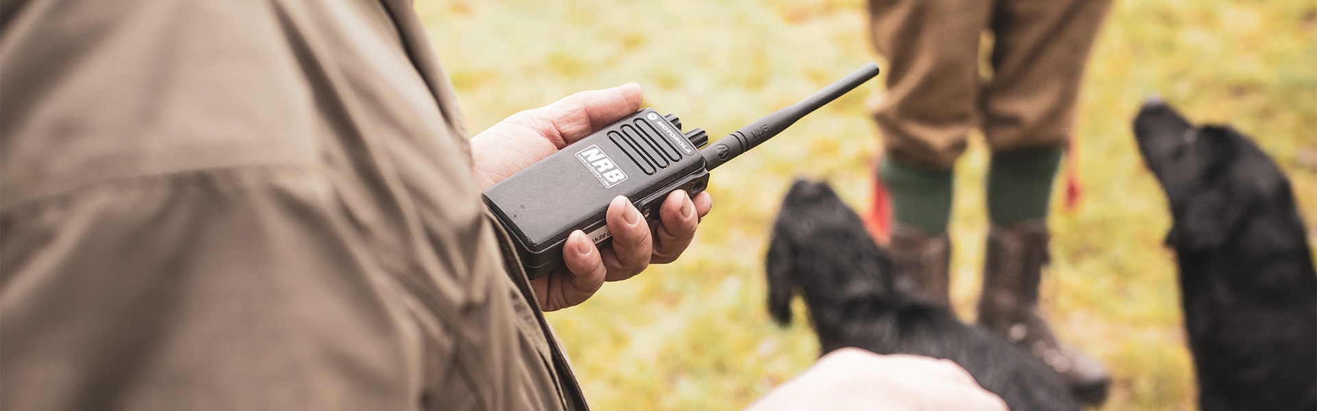 A game shooter holding a radio