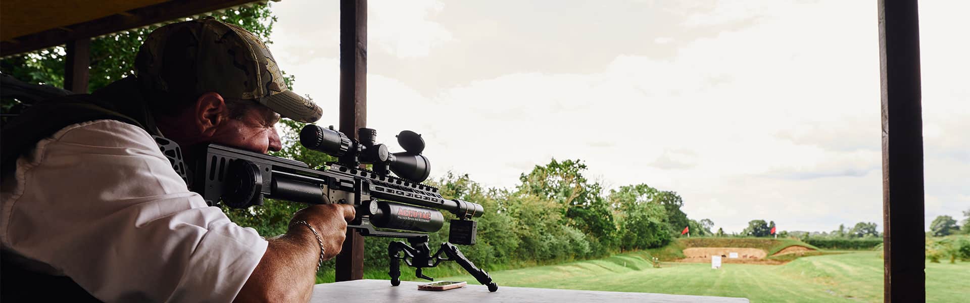 Air rifle shooter aiming down a range