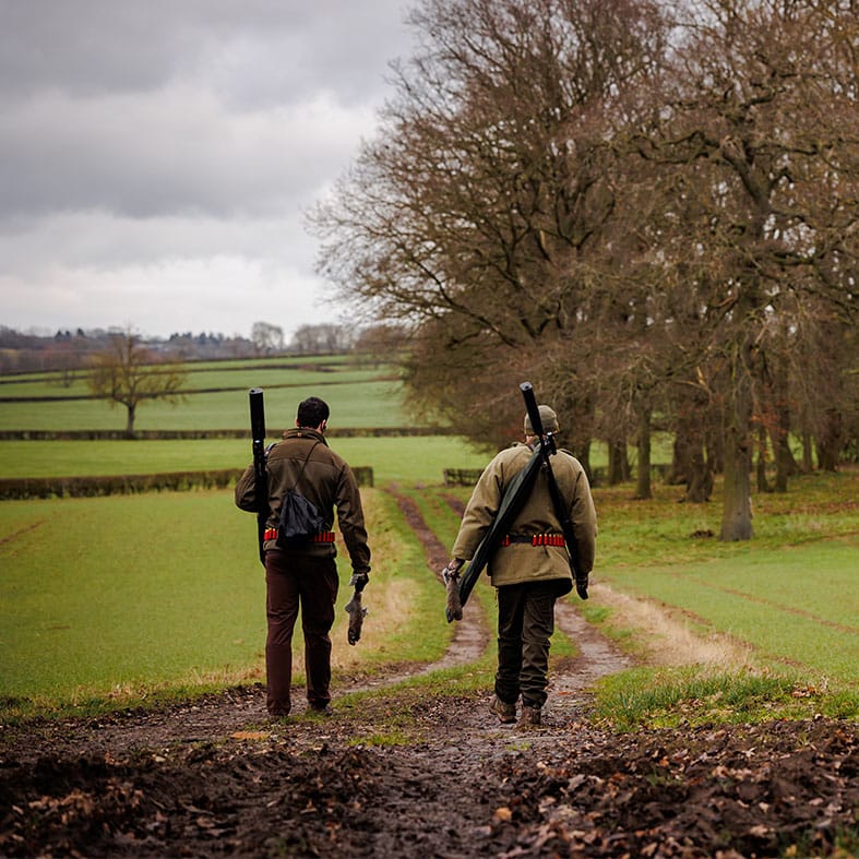 Two shooters walking along a path