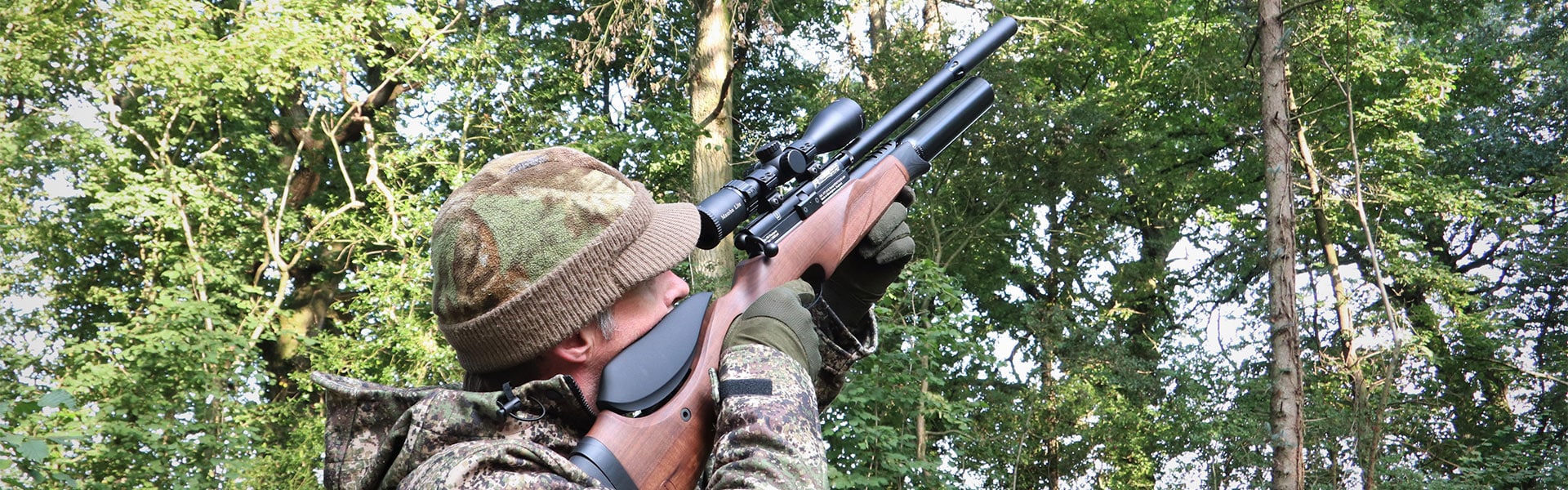 An airgun shooter aiming down the sight of their rifle