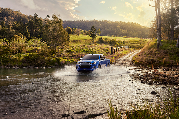 Isuzu 4x4 driving through water