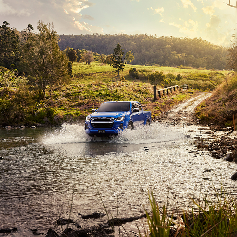 Isuzu 4x4 driving through water