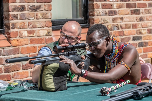 Maasai tribe member shooting an airgun