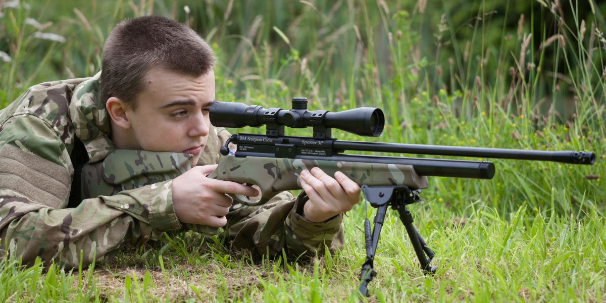 boy shooting airgun in the field