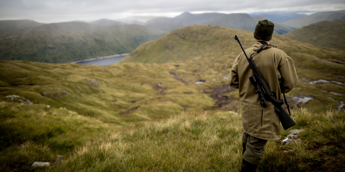 man with rifle stalking