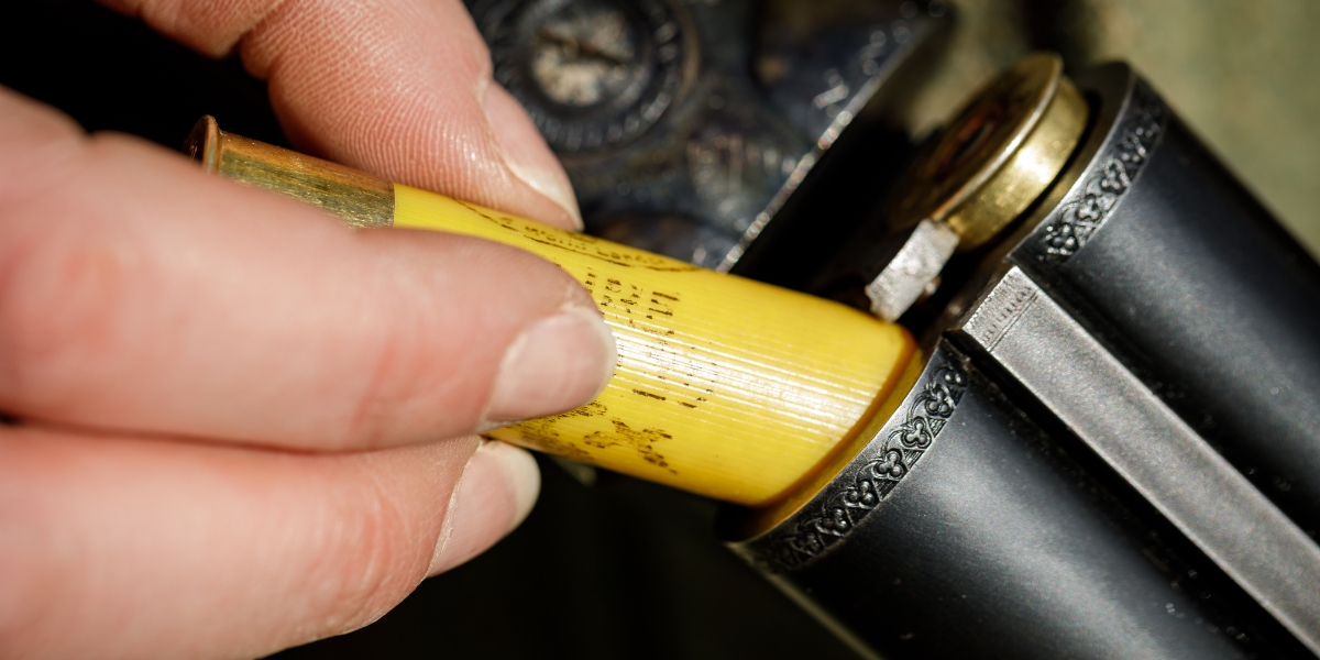 placing cartridge into shotgun