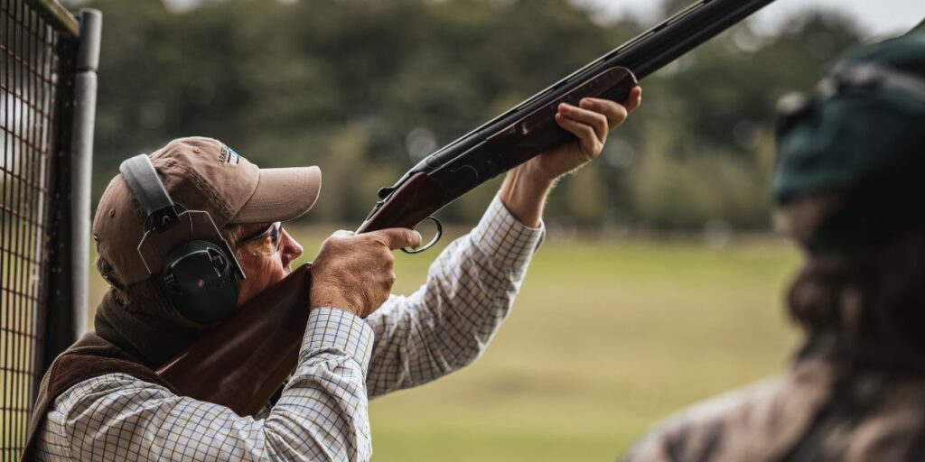 man shooting shotgun