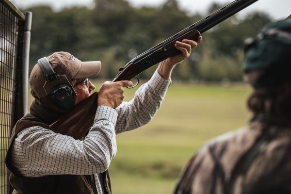 man shooting shotgun