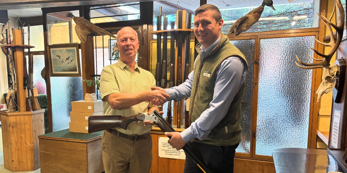 Melvyn Bowers receiving gun draw prize