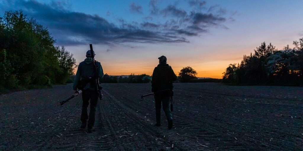 Two night shooters walking