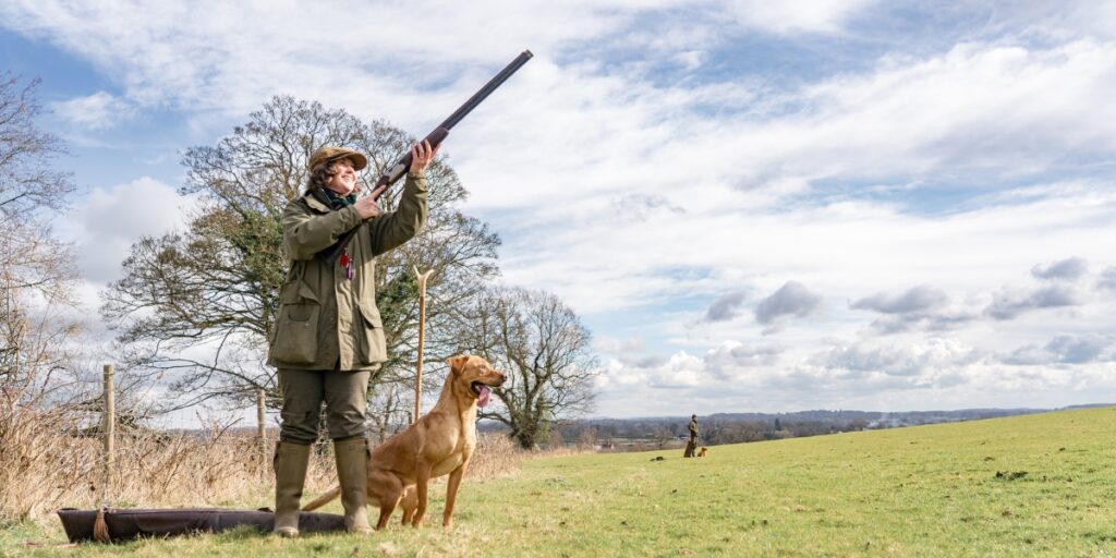 Gun on field with dog